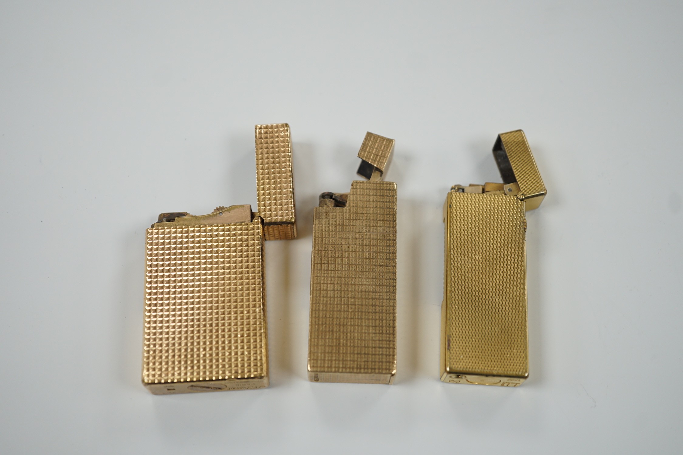 Three Dupont gilt metal lighters